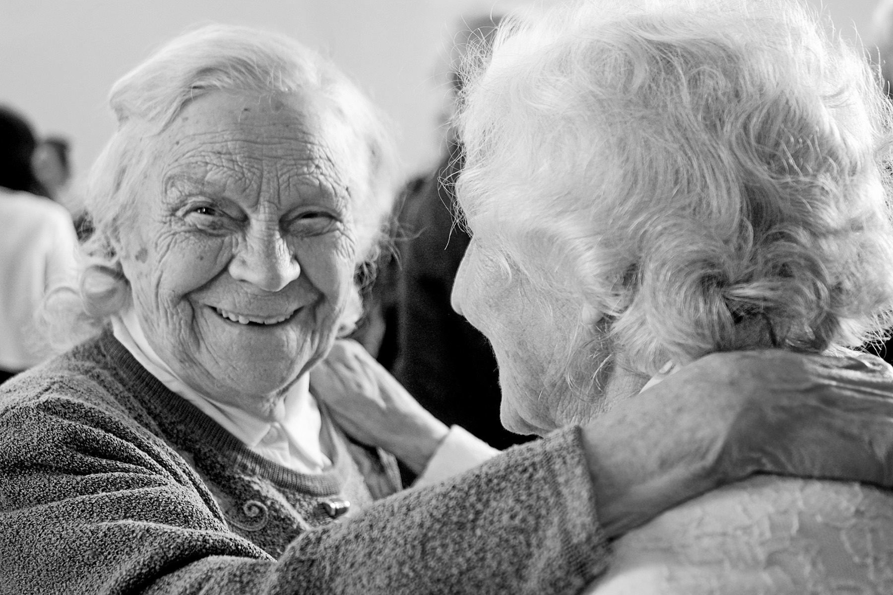 An elderly woman speaking, being interviewed